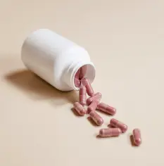 Capsules spilling out of a plastic bottle